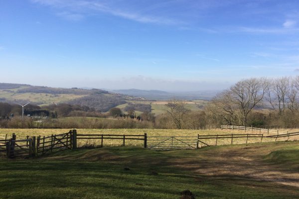 An old wooden fence in a beautiful mountain landscape under the blue sky